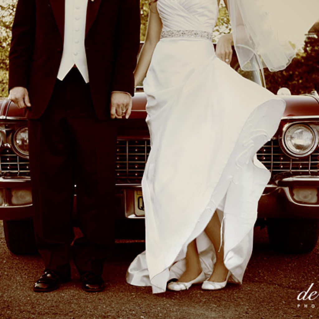 Couple next to old car